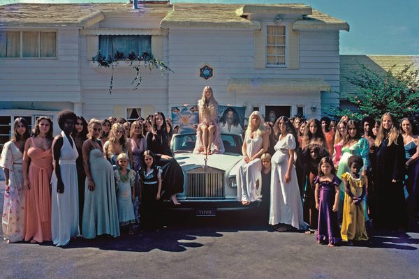 The women of the Source Family pose on a Rolls-Royce for an ad for the release of a recording of the cult's band, Ya Ho Wha 13.